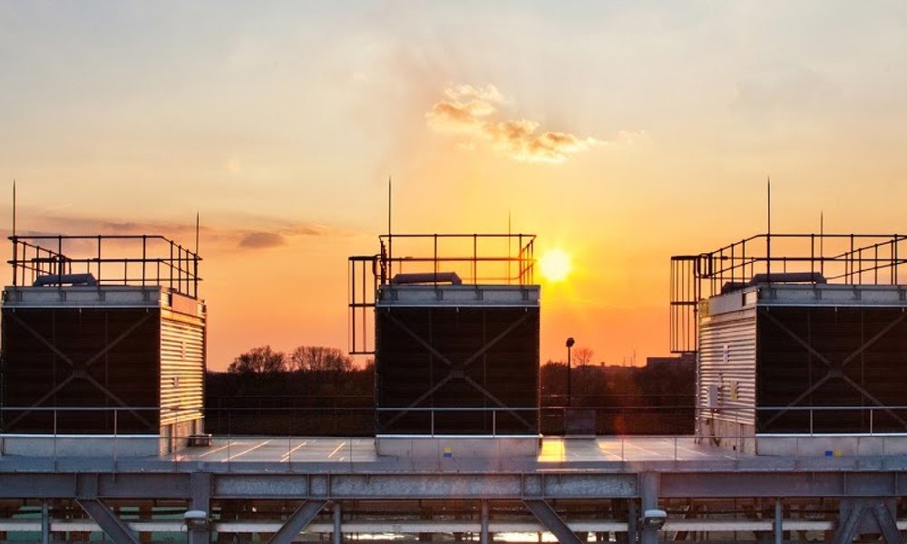 Cooling towers and infrastructure at sunset